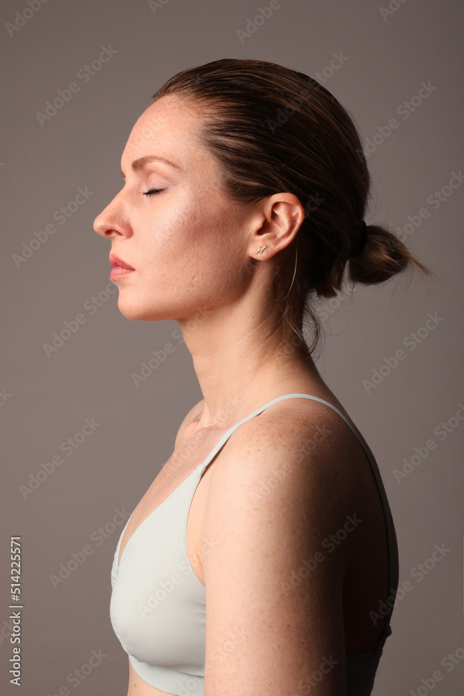 Young and attractive woman with perfect skin posing indoor over white wall. Young and attractive woman with perfect skin posing indoor over white wall.