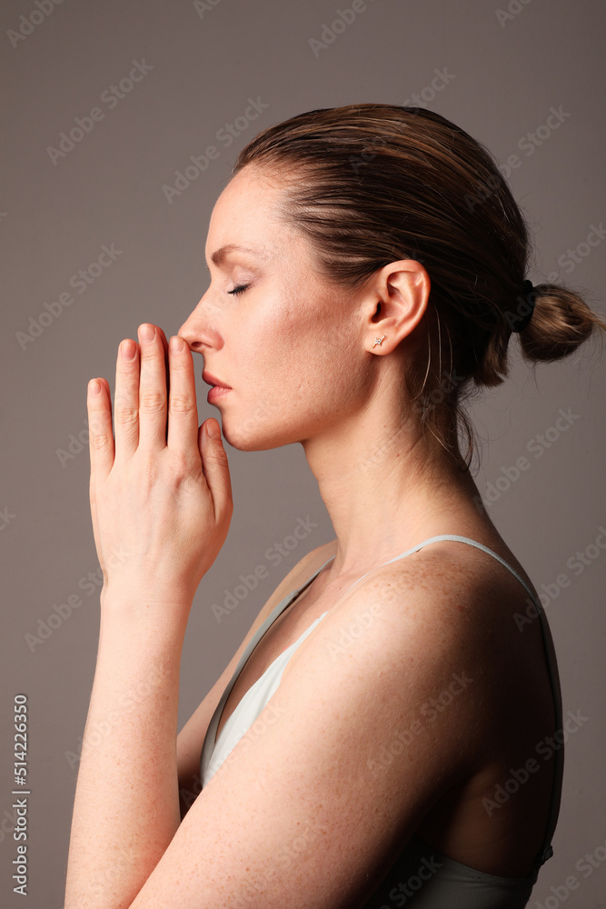 Yoga woman meditates with closed eyes over grey background. Healthy life. Yoga woman meditates with closed eyes over grey background. Healthy life.