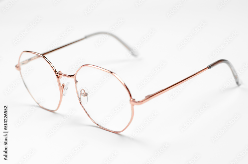 Stylish eyeglasses on a white background. Iron frame glasses Stylish eyeglasses on a white background. Iron frame glasses