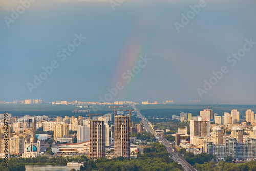 Skyline of Kyiv with Metro bridge and rainbow in the sky.