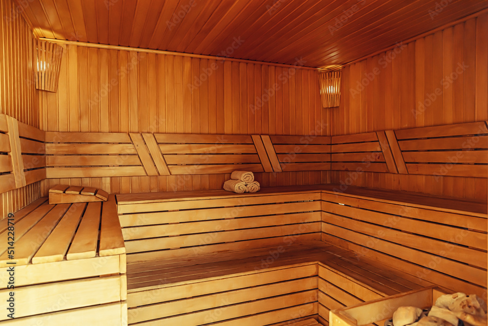 Interior of Finnish sauna, classic wooden sauna with hot steam. Russian bathroom. Relax in hot sauna with steam. Wooden interior baths, wooden benches and loungers accessories for sauna, spa complex Interior of Finnish sauna, classic wooden sauna with hot steam. Russian bathroom. Relax in hot sauna with steam. Wooden interior baths, wooden benches and loungers accessories for sauna, spa complex