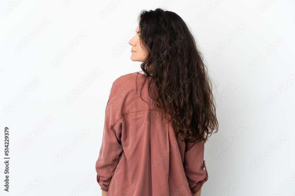 Teenager Russian girl isolated on white background in back position and looking side Teenager Russian girl isolated on white background in back position and looking side