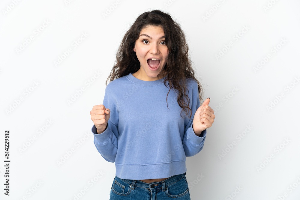 Teenager Russian girl isolated on white background celebrating a victory in winner position