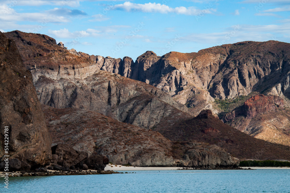 Red rocks of the protected biosphere reserve on Balandra beach in Baja California Sur, Mexico. Nature landscape of a virgin beach in the Gulf of California. Red rocks of the protected biosphere reserve on Balandra beach in Baja California Sur, Mexico. Nature landscape of a virgin beach in the Gulf of California.