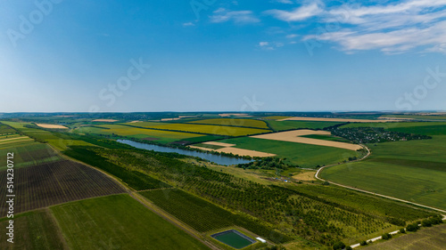 aerial view of field of wheat and vineyard and lake