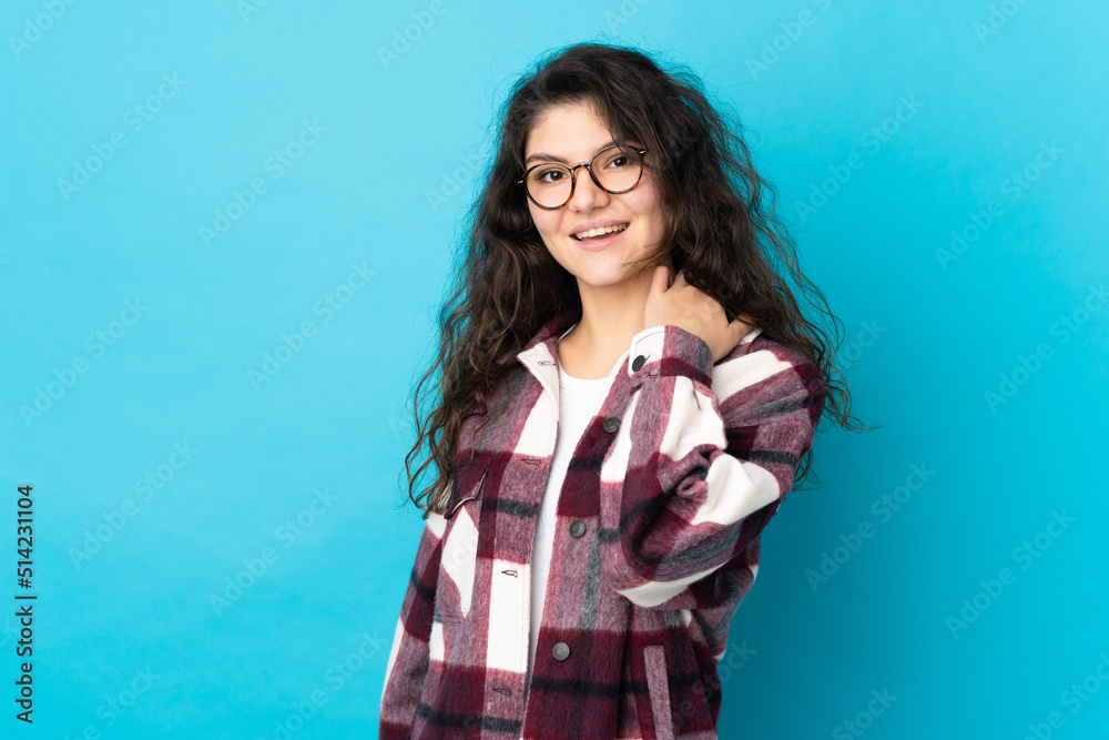 Teenager Russian girl isolated on blue background laughing Teenager Russian girl isolated on blue background laughing