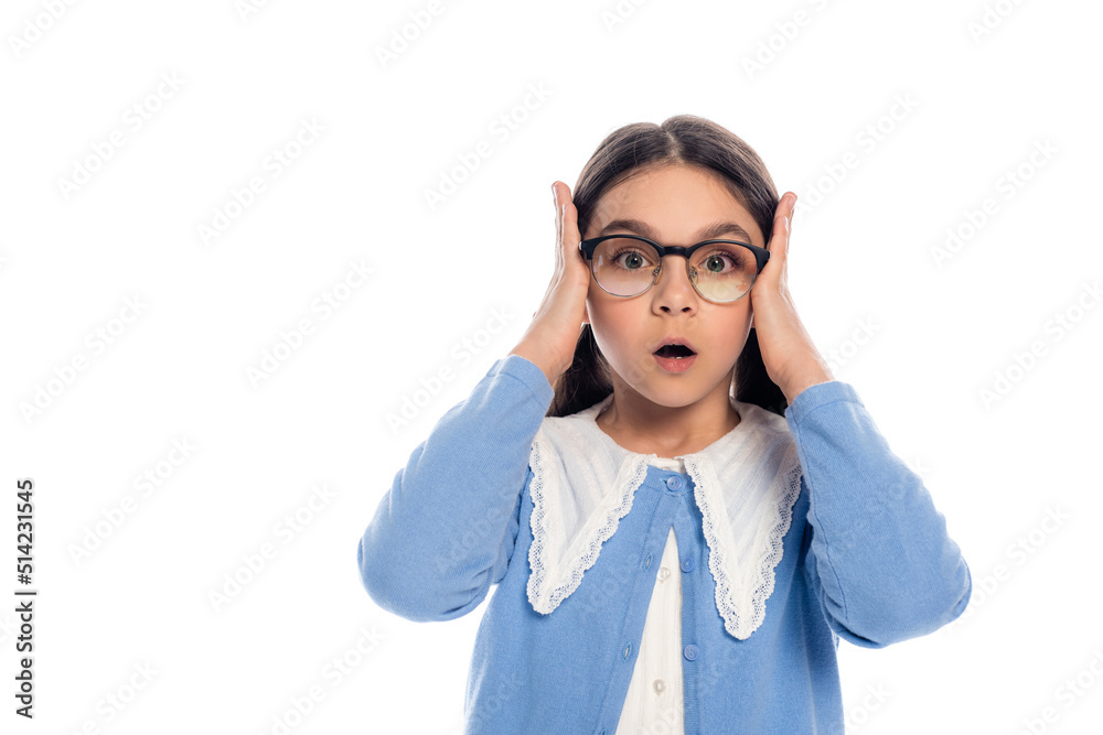 Shocked schoolkid in eyeglasses holding hands near head isolated on white. Shocked schoolkid in eyeglasses holding hands near head isolated on white.