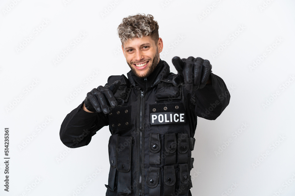 SWAT caucasian man isolated on white background points finger at you while smiling SWAT caucasian man isolated on white background points finger at you while smiling