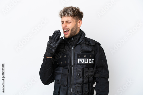 SWAT caucasian man isolated on white background yawning and covering wide open mouth with hand