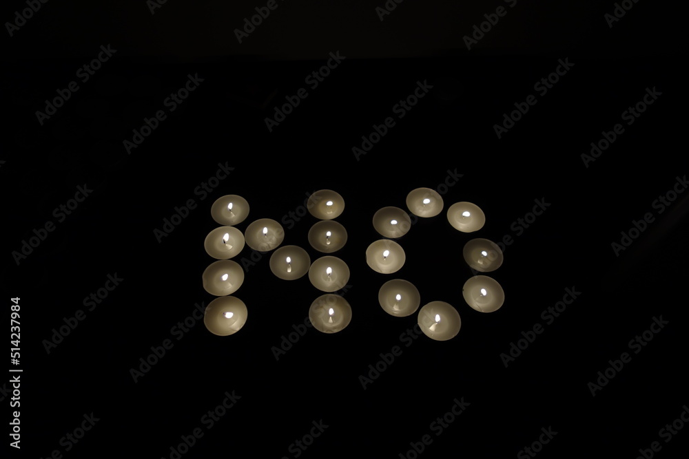 word no written with burning candles isolated on black background word no written with burning candles isolated on black background