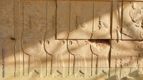 Carved stones with persian soldiers in famous Persepolis archeological site photo