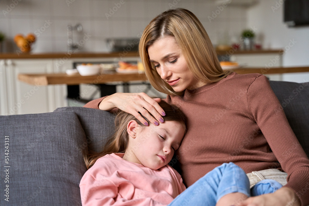 Young loving affectionate mother caressing cute kid daughter bonding sitting on couch. Tender beautiful mom holding adorable child girl at home relaxing on sofa in living room. Young loving affectionate mother caressing cute kid daughter bonding sitting on couch. Tender beautiful mom holding adorable child girl at home relaxing on sofa in living room.