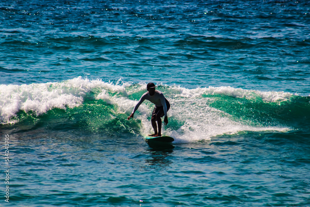 amazing surfer riding the waves silhouette  in carrizalillo beach puerto escondido oaxaca 