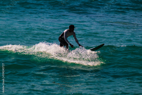 blue intense sea with a surfer ride the waves in carrizalillo puerto escondido oaxaca 