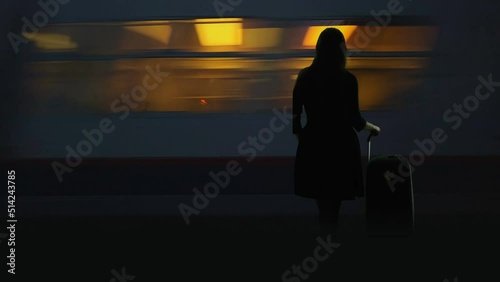 Woman silhouette stand with back in station  platform, train pass fast, new life