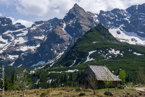 Gasienicowa Valley. Tatra Mountains. An old hut in the background of the Koscielec peak.