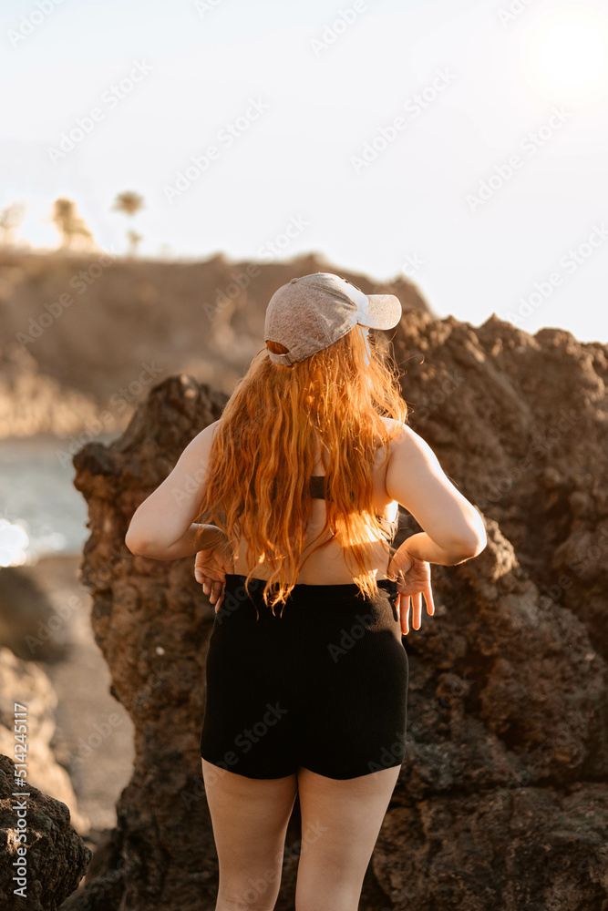 Girl with surfer style in front of the beach