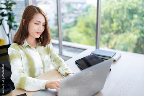 A photo of a bright Asian business woman working at home in the room. The idea is Work form Home Finance Marketing Bright Portrait Simple Break The Science Bias