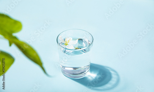 Fresh clear water drink with white flower apple tree in glass