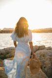 Anonymous stylish lady admiring sunset over sea