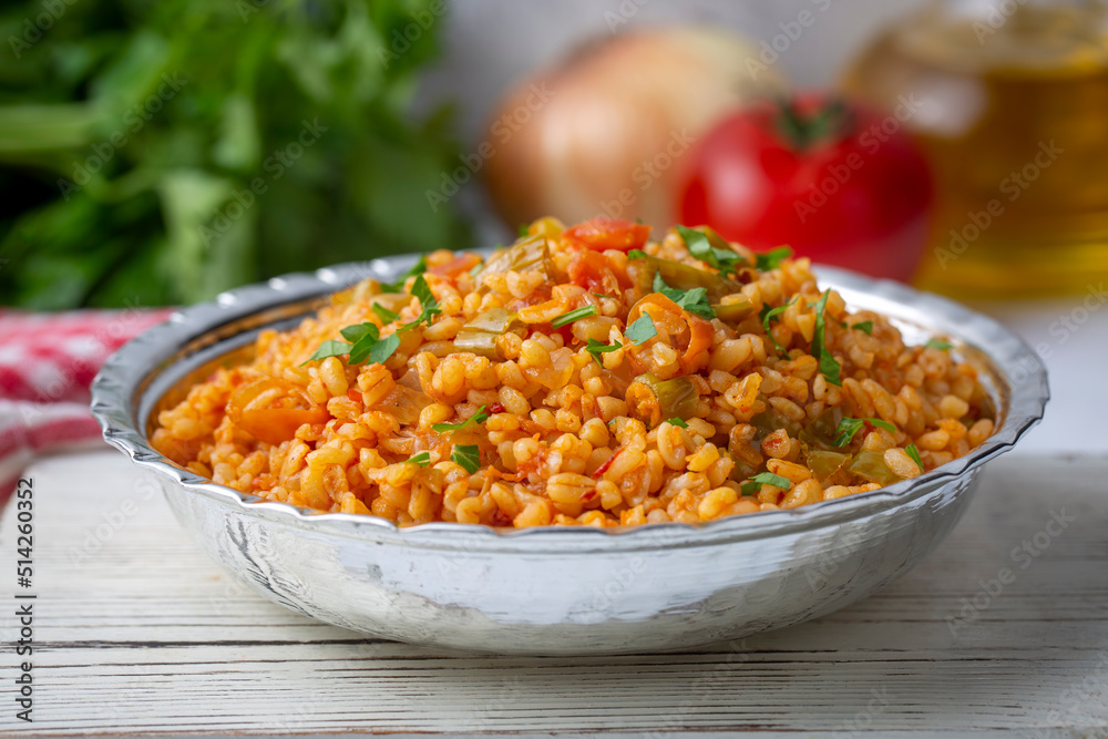 Traditional turkish bulgur pilaf with tomato sause in plate (Turkish name; meyhane pilavi) Traditional turkish bulgur pilaf with tomato sause in plate (Turkish name; meyhane pilavi)