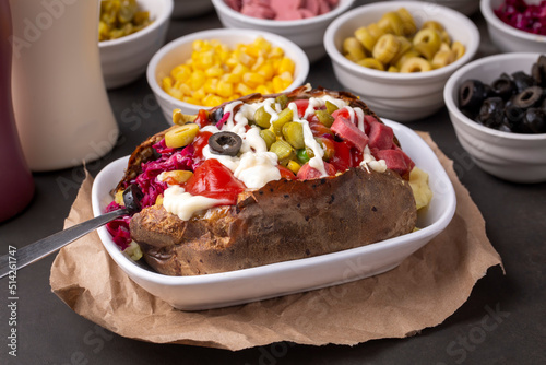 Obraz na płótnie Kumpir, Turkish baked potato with cheese, corn, sausage, ketchup, mayonnaise and olives. This kumpir is traditional turkish food w salonie
