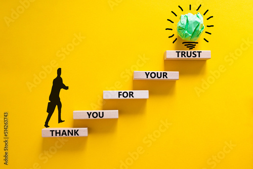 Thank you for trust symbol. Concept words Thank you for your trust on wooden blocks on a beautiful yellow table yellow background. Businessman icon. Business and thank you for trust concept.