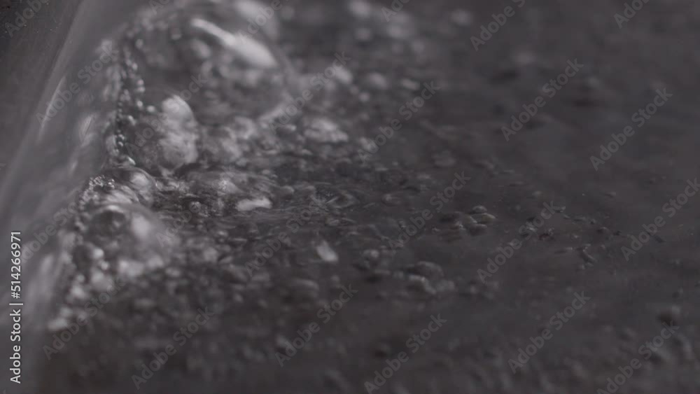 Boiling water in a pot bubbling