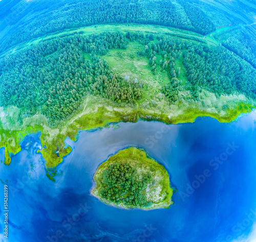 Big lake and island with green shores with morning fog in dawn, aerial landscape. Recreation concept. Aerial view