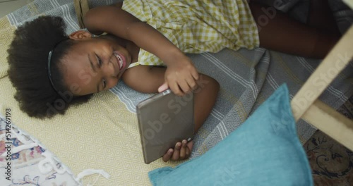 Video of happy african american girl using using technology photo