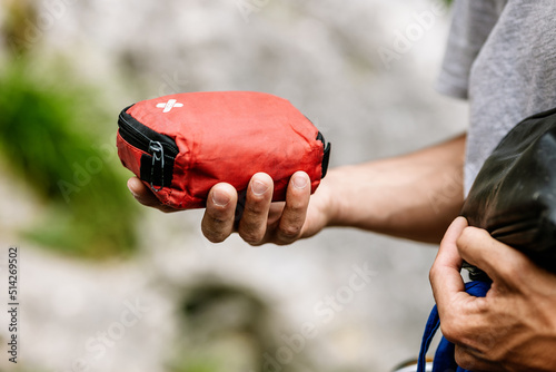 Male Hiker Holding Red Pouch photo