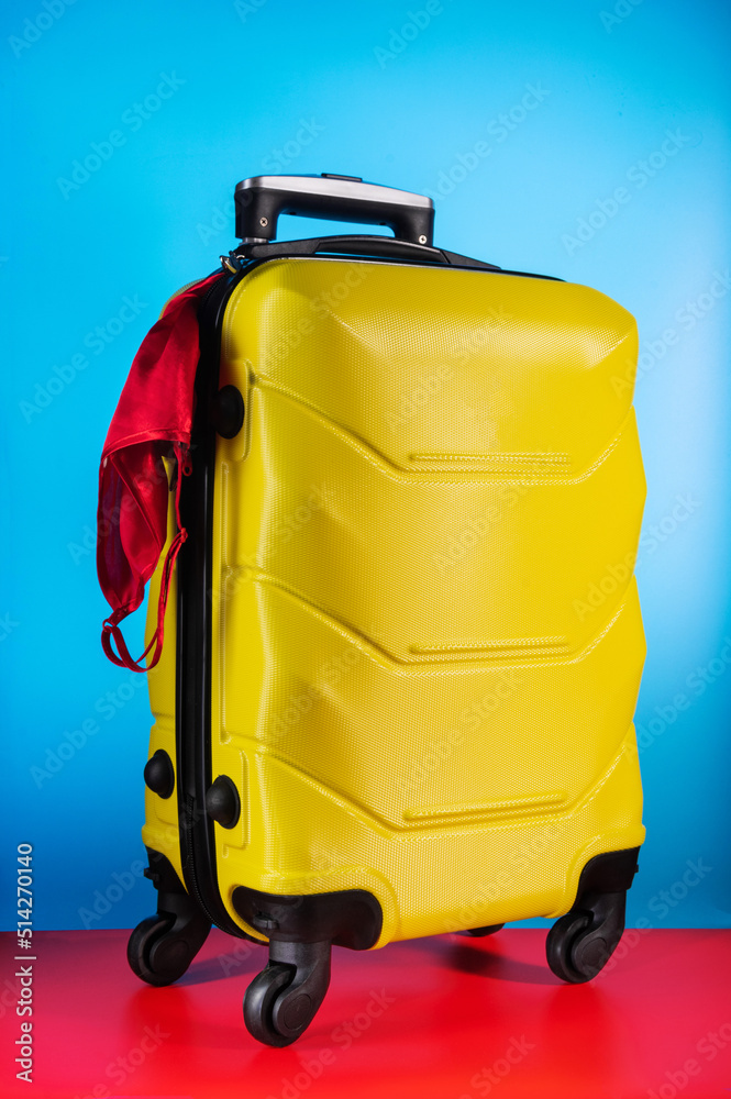 Red lingerie in a suitcase. Women's underwear is sticking out of the suitcase. The woman leaves. Women's luggage. Red lingerie in a suitcase. Women's underwear is sticking out of the suitcase. The woman leaves. Women's luggage.