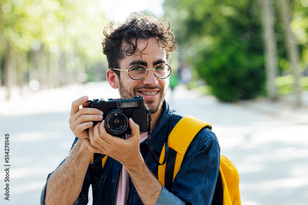 Young man taking photos in Madrid with an analog camera. Young man taking photos in Madrid with an analog camera.