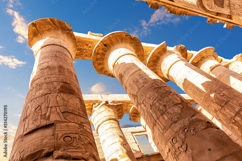 Columns with ancient carvings in the Great Hypostyle Hall of Karnak Temple, Luxor, Egypt