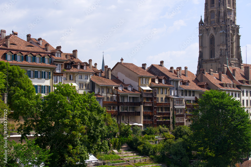 Aerial view of the old town of City of Bern with historic houses, Minster and Aare River on a blue cloudy summer day. Photo taken June 16th, 2022, Bern, Switzerland.