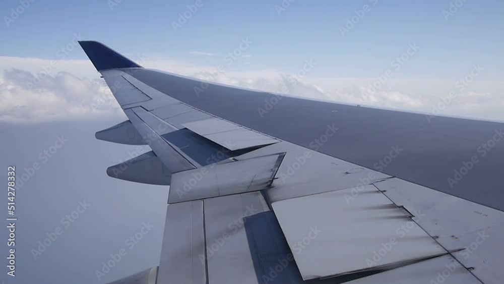 Airplane wing with clouds