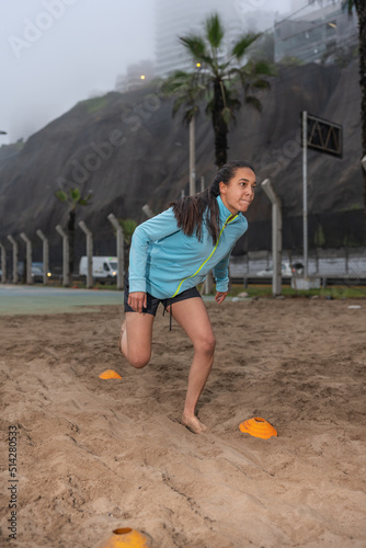 Woman doing a functional training on the beach photo