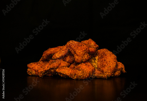 Spicy chicken wings with black background
