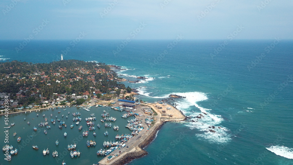 Small fishing harbour in the southern coast of Sri Lanka. Many small fishing boats parked till they go fishing again in the ocean.