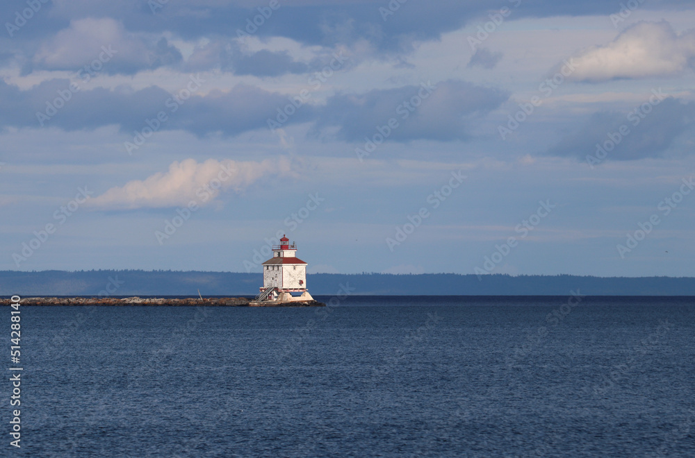 Sun shining on the lighthouse that guides the vessels of the Great lakes - Thunder Bay Marina, Ontario, Canada