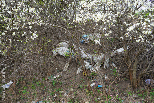 A pile of rubbish in a clearing in the countryside on a spring day. Concept of ecology. Out of focus.