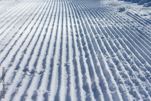 Snow stripes. Snow groomer print  close-up.