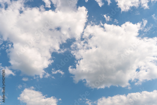 Beautiful white fluffy clouds on a blue sky background on a sunny day.