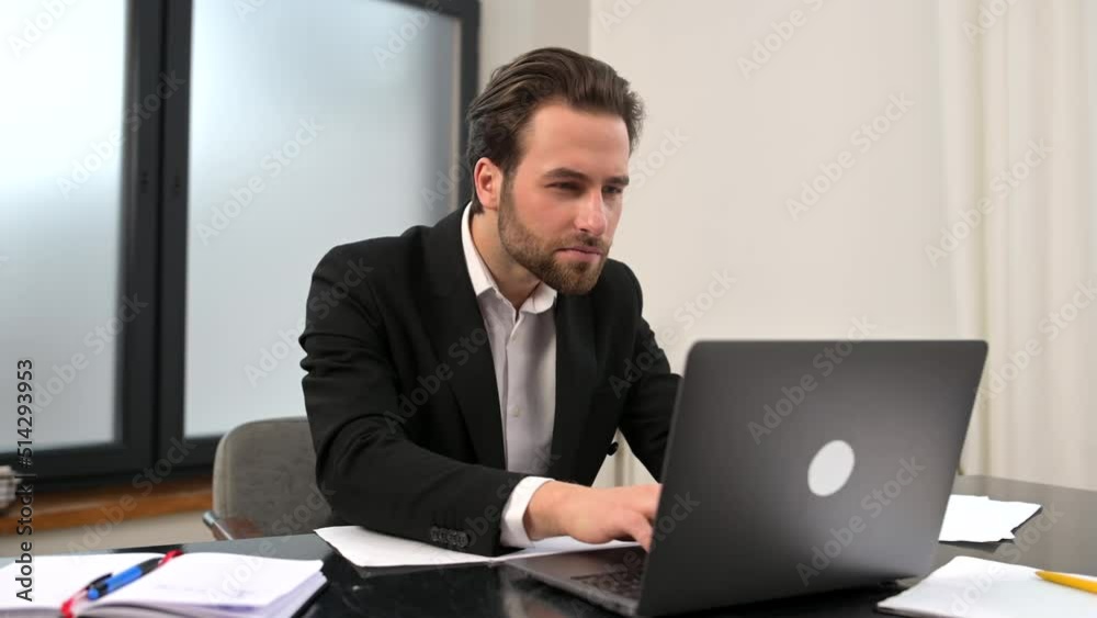 Crazy excited lucky young bearded businessman sitting at the desk with laptop, raised fists up celebrating success, making yes gesture, got job promotion, got promoted, won lottery, victory concept Crazy excited lucky young bearded businessman sitting at the desk with laptop, raised fists up celebrating success, making yes gesture, got job promotion, got promoted, won lottery, victory concept