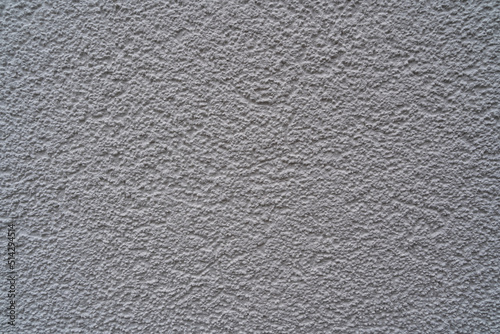 Plaster structure with 2 mm grain on a white exterior facade of a house