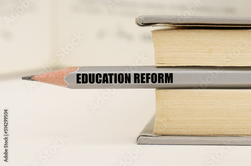 In the book between the pages lies a pencil with the inscription - Education Reform photo