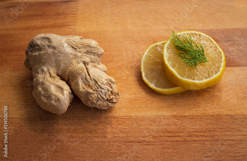 fresh ginger and lemon on wooden background photo