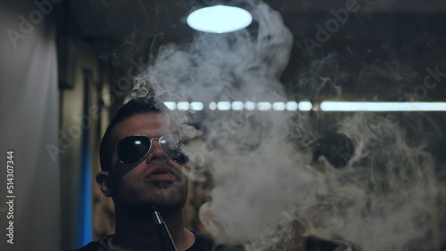 Arabic jordanian young man smokes a hookah. photo