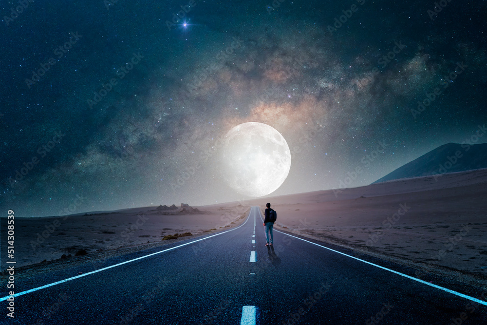 road to the moon in the desert at night with silhouette of a person - obrazy, fototapety, plakaty 