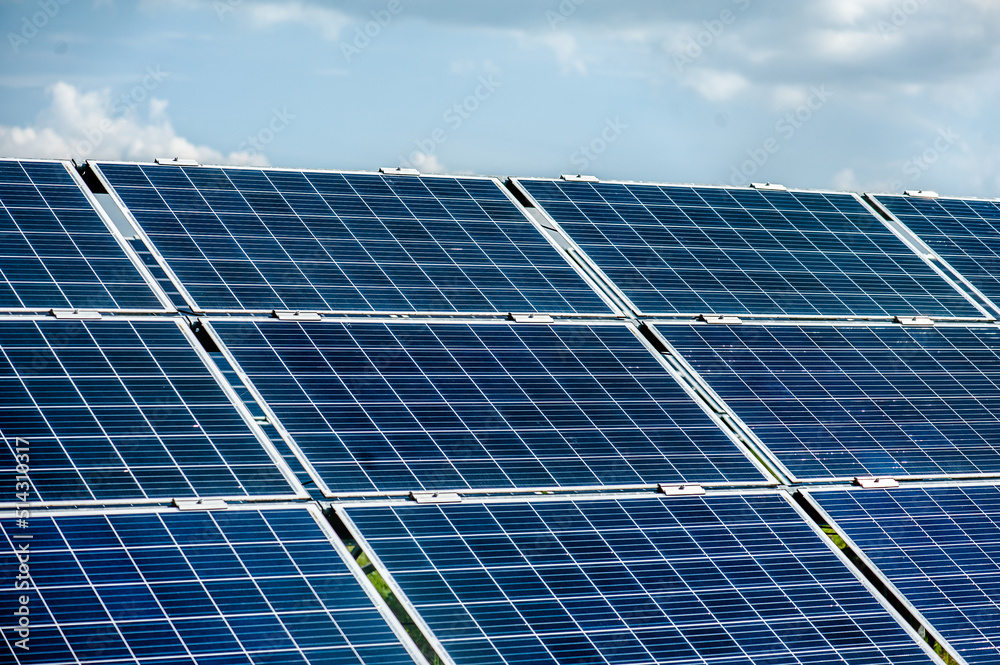 Solar panels and blue sky. Solar panels system power generators from sun. Clean technology for better future Solar panels and blue sky. Solar panels system power generators from sun. Clean technology for better future